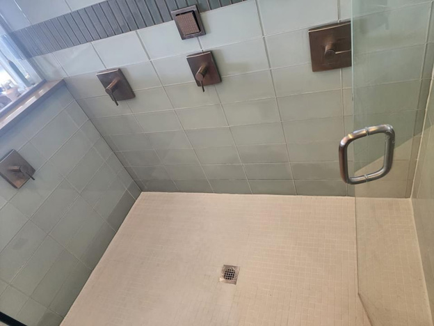 Shower restoration with cleaned tile walls and refreshed shower floor